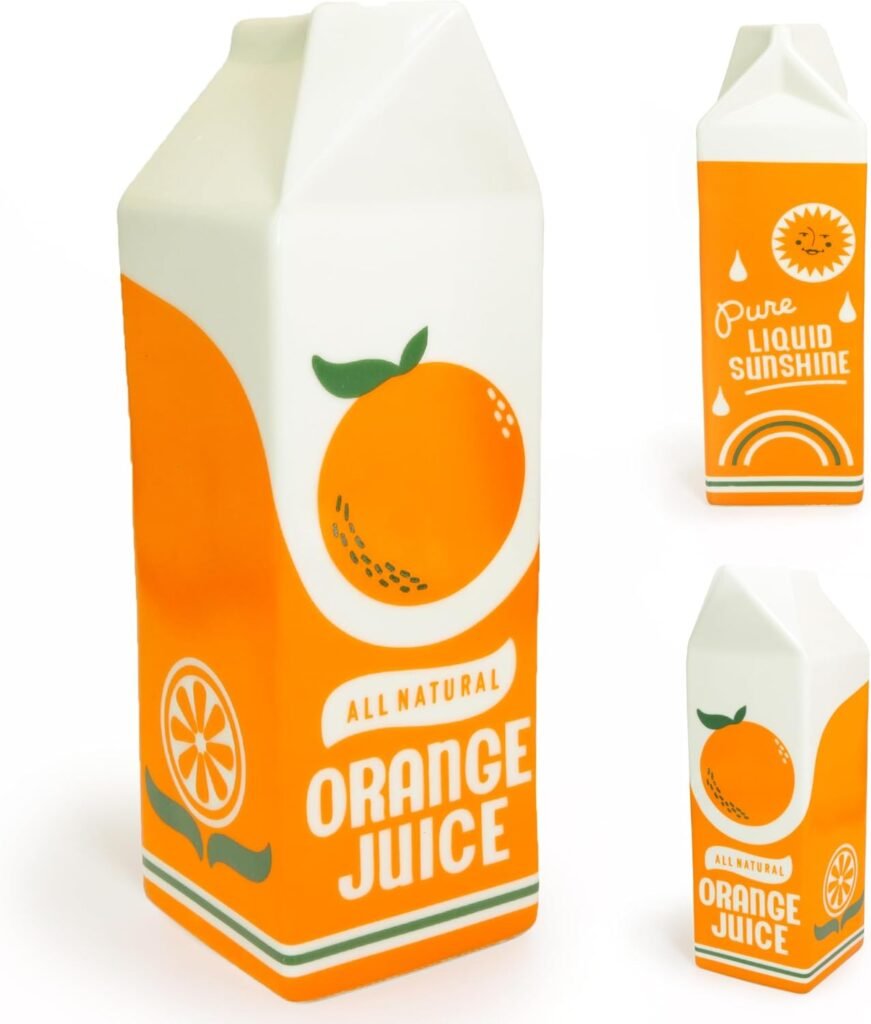 A white ceramic vase shaped like a juice carton, placed on a side table