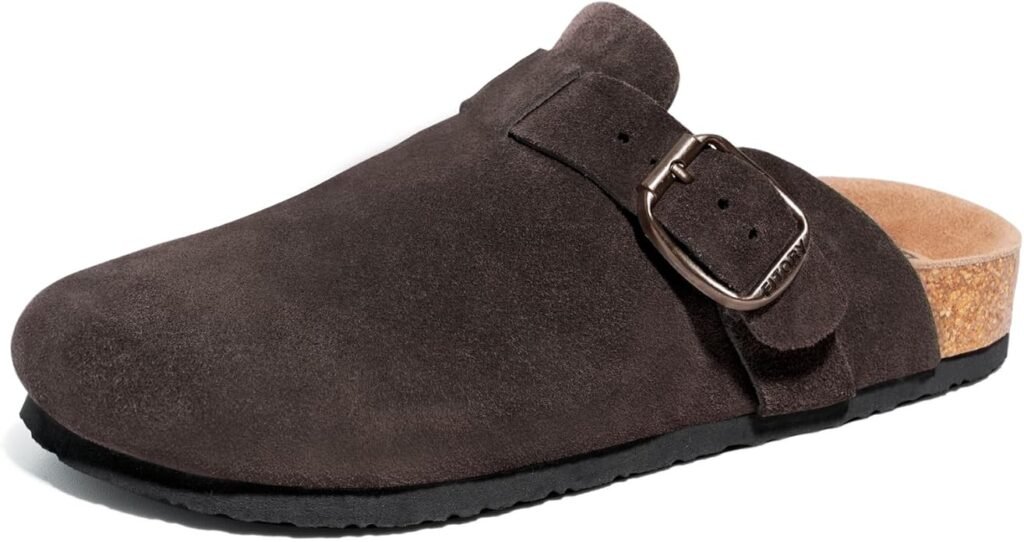 Brown suede clog with cork footbed and buckle detail on white background