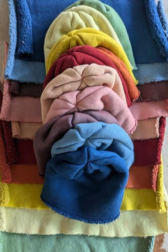 A stack of pastel and bold fabric samples showcasing the palette Skylrk is drawing from. Softness and vibrancy side by side.