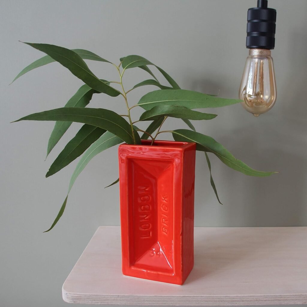 A bold ceramic vase shaped like a London brick. Brutalist meets pop art — great as a punchy shelf accent in minimalist homes.