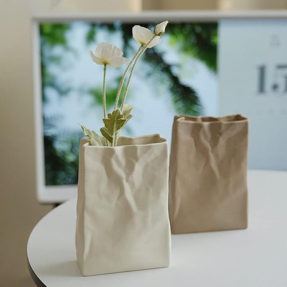 Decorative Vases - This sculptural ceramic vase mimics a crumpled paper bag — weird, minimalist, and texturally interesting. A quiet standout on neutral shelves.