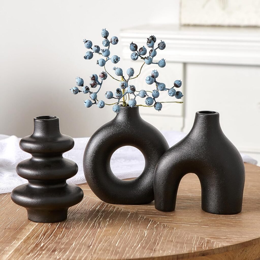 A trio of abstract black vases with matte finishes and distinct shapes — ideal for monochrome shelves or minimalist interiors.