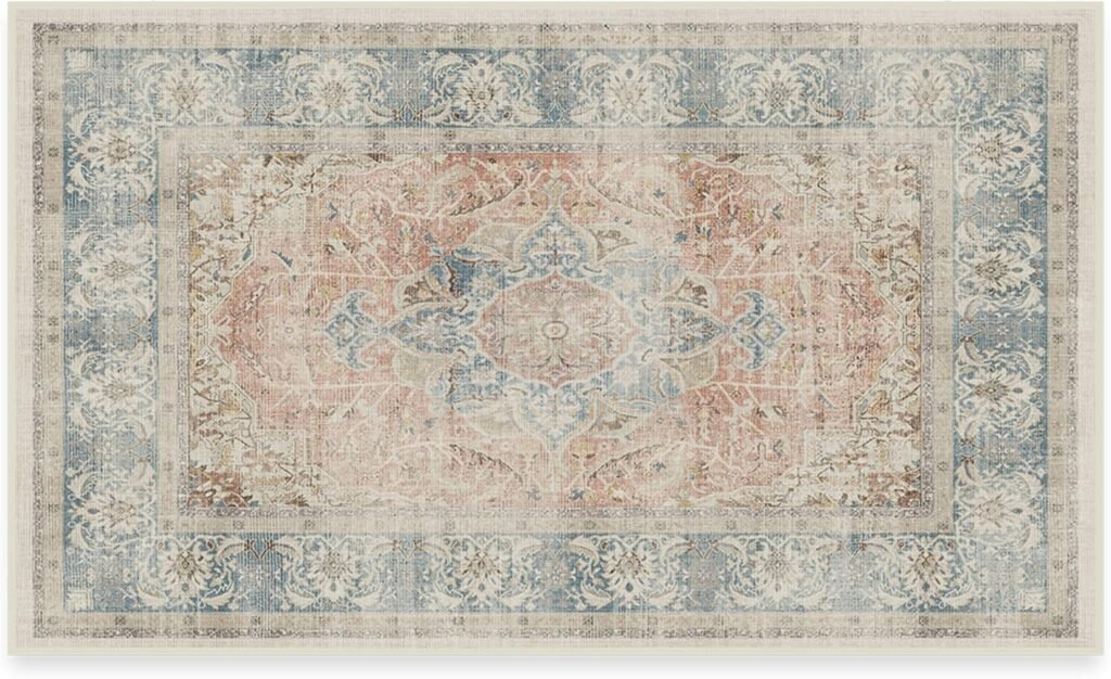 Vintage distressed rug with blush pink and blue tones in a faded oriental pattern
