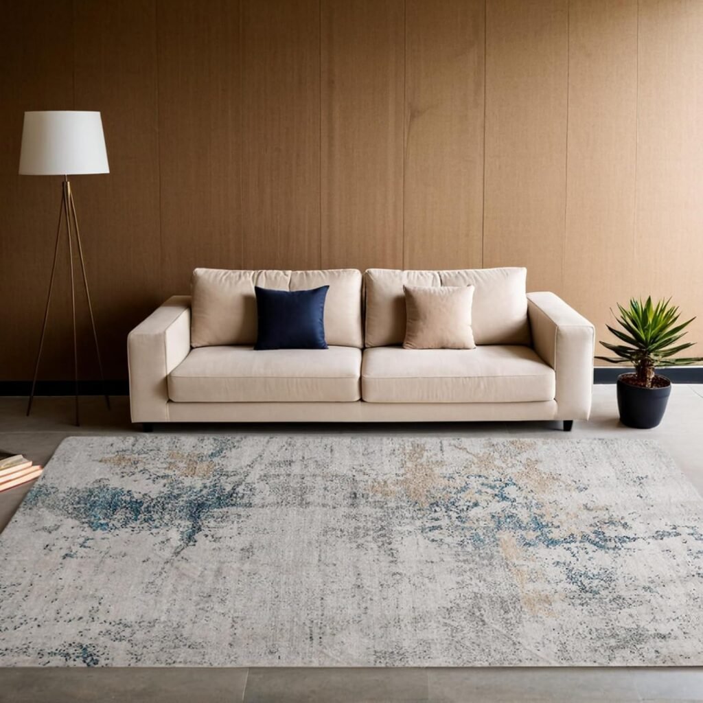 Neutral distressed rug with grey, blue, and beige tones in a minimal beige lounge