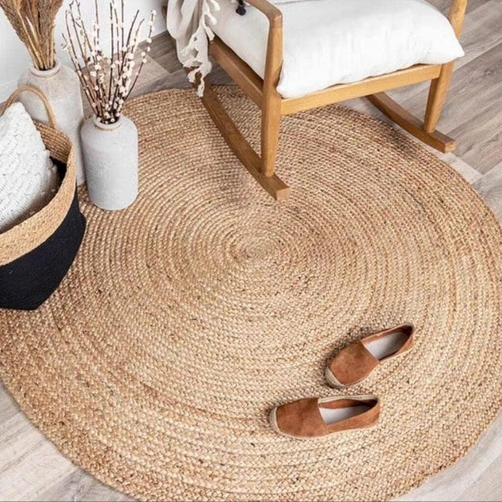 Round woven jute rug with natural texture next to a wooden rocking chair