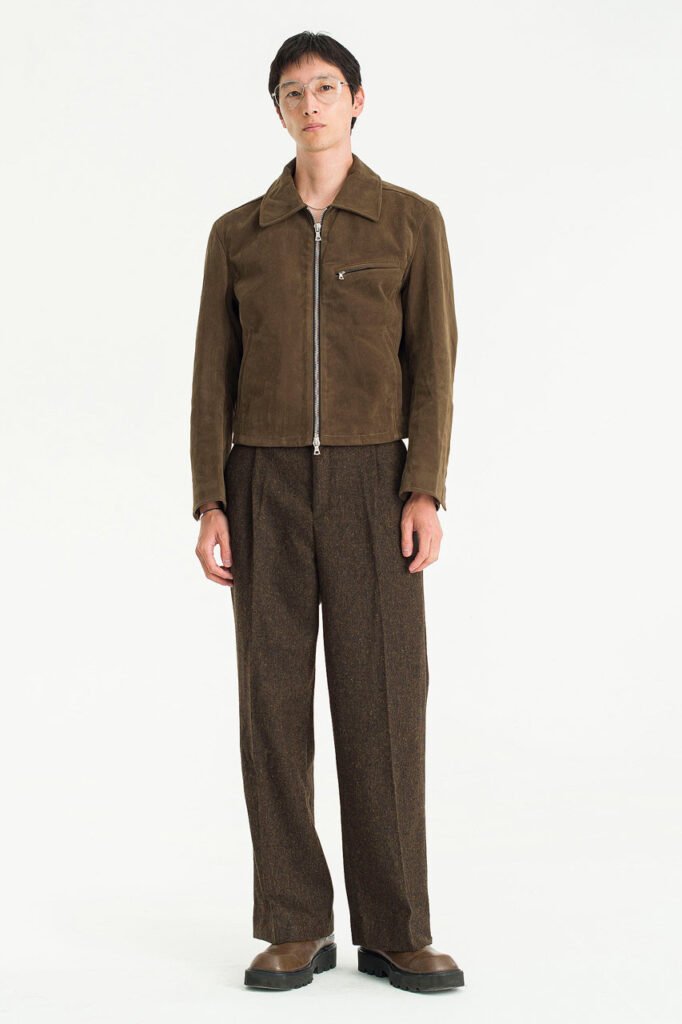 A model wears chestnut brown wide-leg trousers from Olive Clothing’s menswear collection.