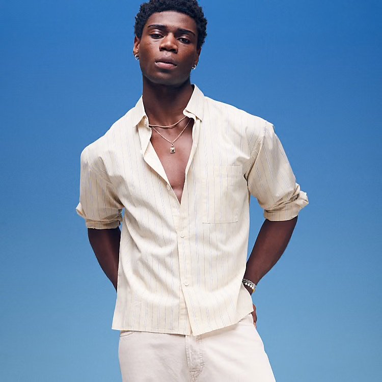 Model wearing a white cotton long sleeve summer shirt from Cotton On, styled casually.