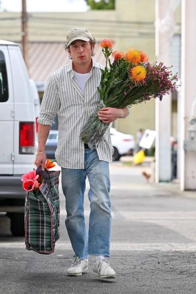 Jeremy Allen White wearing a white Oxford shirt with tailored yet relaxed styling.