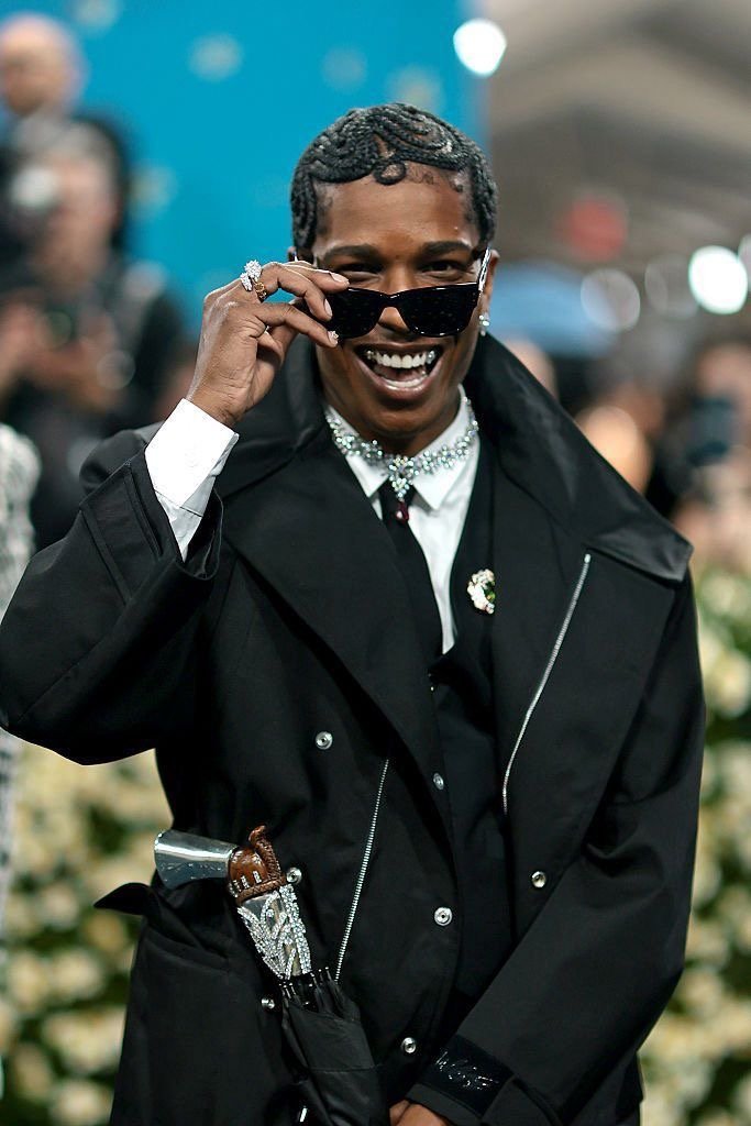 ASAP Rocky at the 2025 Met Gala wearing a black coat, diamond jewellery, and a gun-handled umbrella.