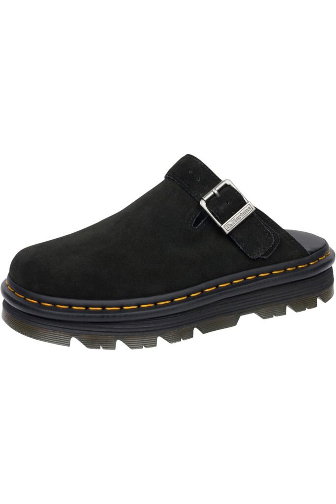 Black suede Dr. Martens Zeb Zag mule with yellow stitching and chunky sole on a clean white backdrop.