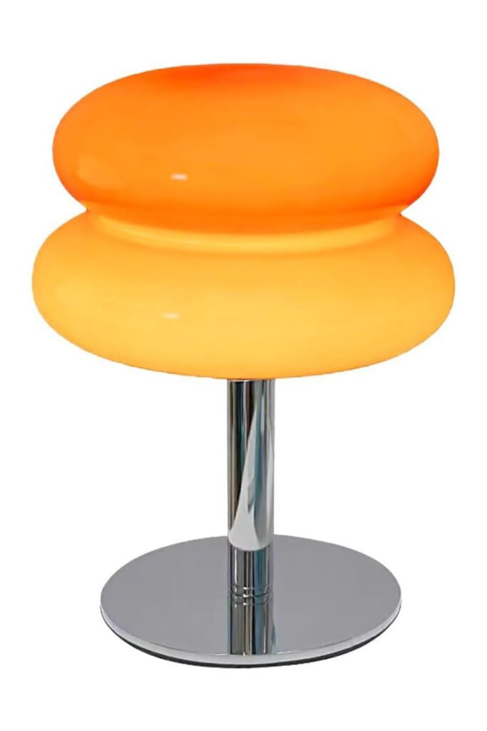 Small mushroom-shaped lamp with a warm orange glass shade and chrome base