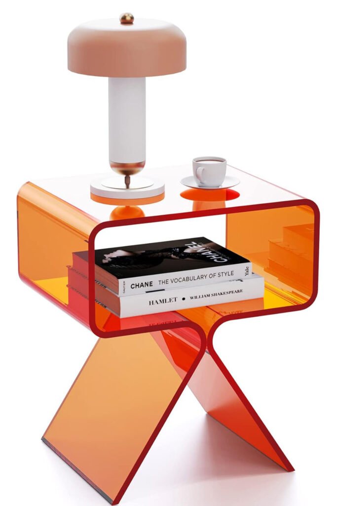 Acrylic orange side table with curved legs and books stacked underneath