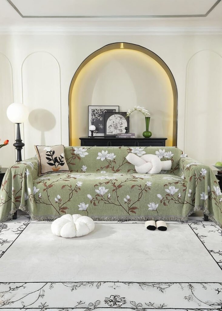 pistachio decor green blanket with white floral print and grey fringe.