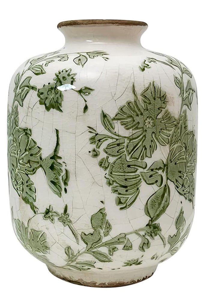 A white ceramic vase with a green leaf pattern and crackled finish.