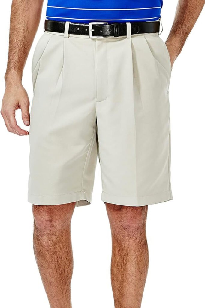 Light beige pleated tennis shorts with belt loops and tailored fit